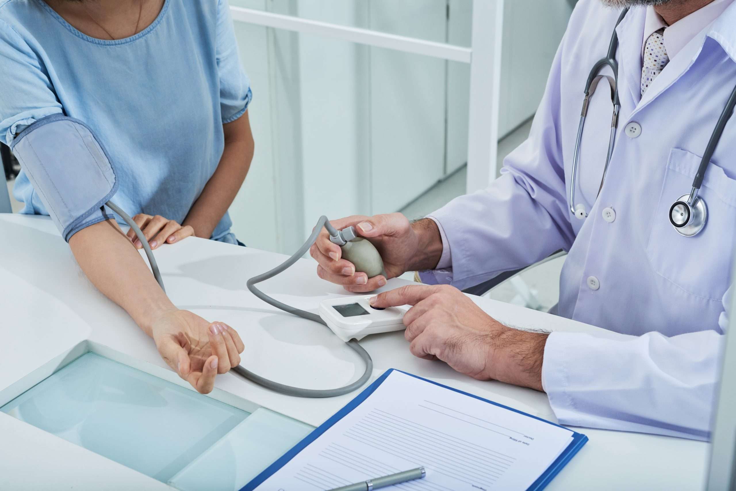 A physician measures a patient’s blood pressure
