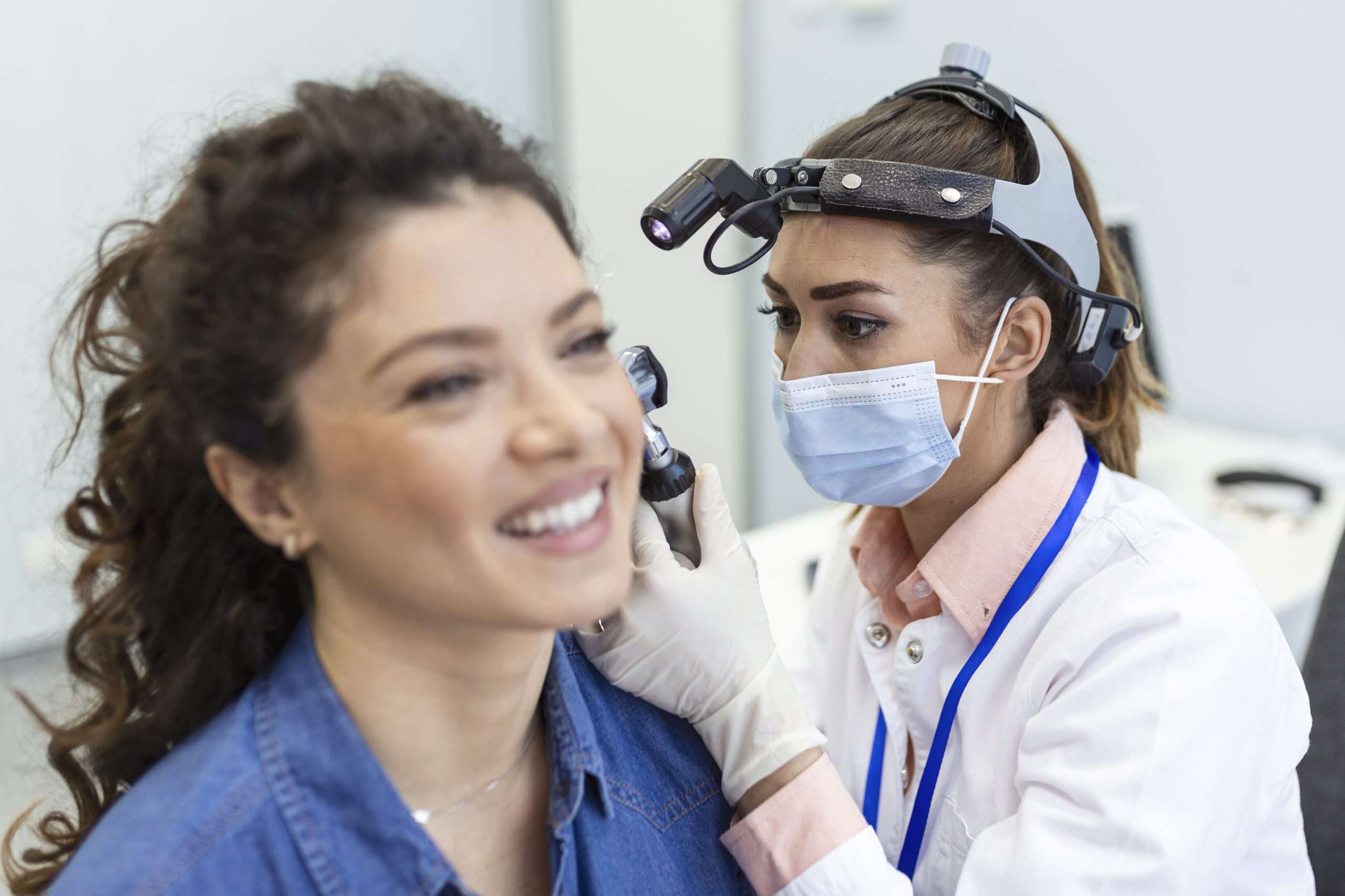 Preventive Care 7 hearing exam otolaryngologist doctor checking woman s ear using otoscope auriscope medical clinic scaled