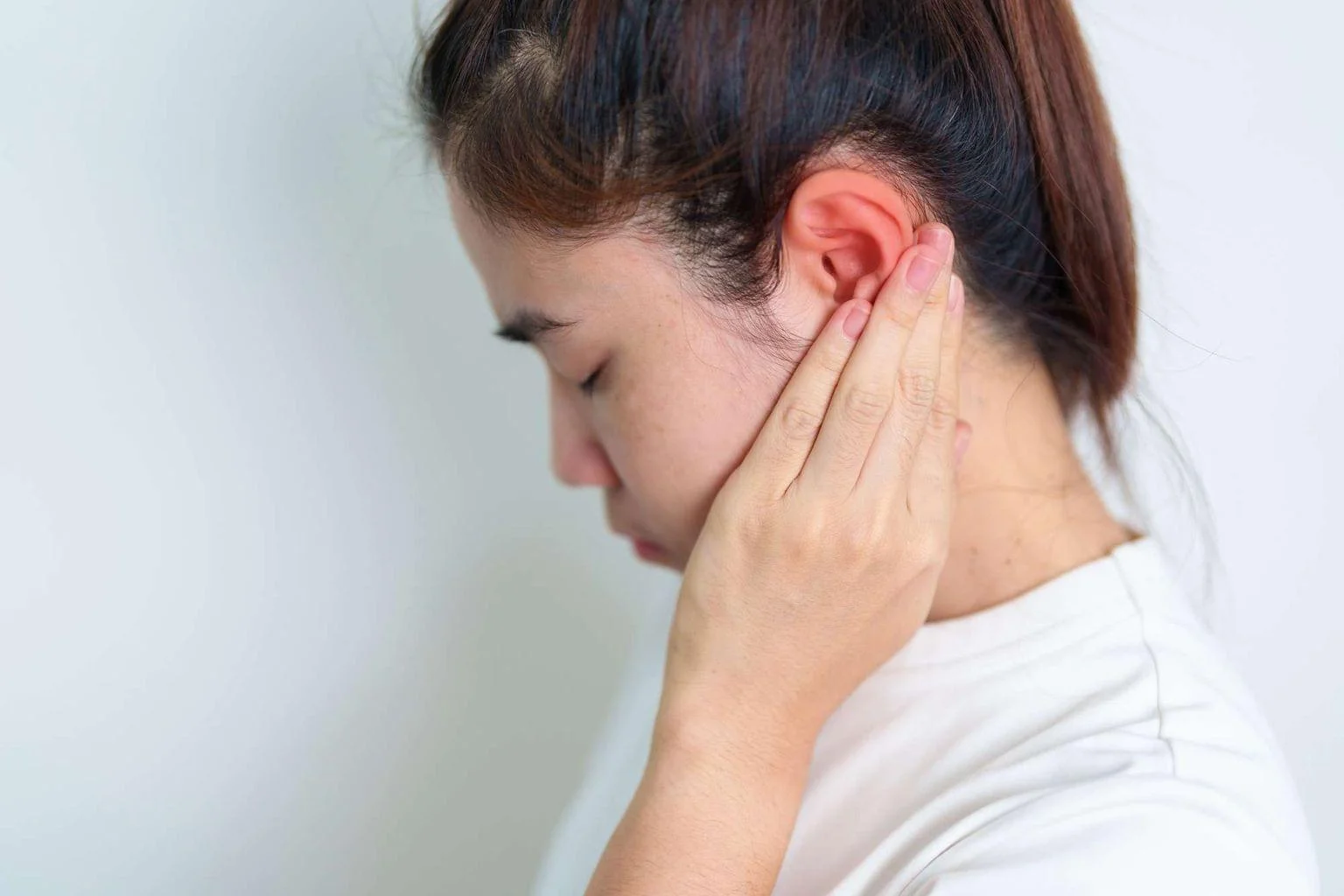 Acute Care Visits 4 woman holding her painful ear ear disease atresia otitis.jpg.bv resized desktop.jpg.bv